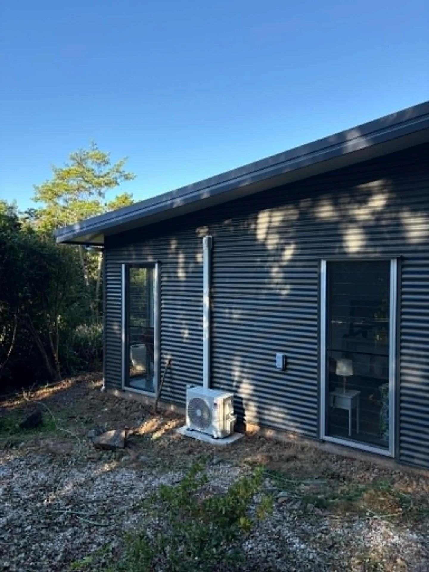 Split system outdoor unit neatly installed beside a Sunshine Coast home